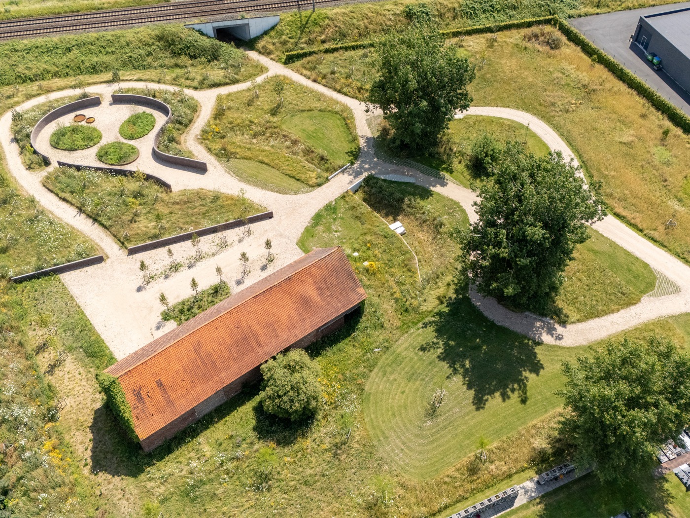 Vogelperspectief van de begraafplaats met overzicht van bloemenvelden en wandelroutes.